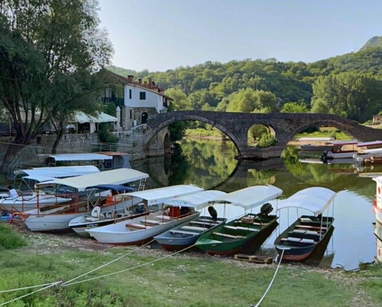 Historic stone bridge with fishing boats